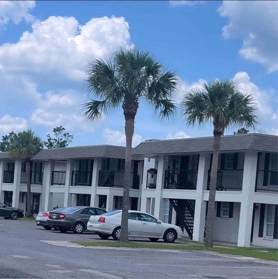 a building with two palm trees in front of it