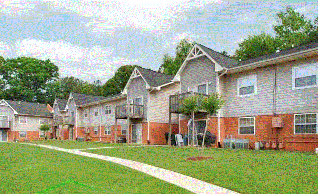 a row of houses with a grassy yard