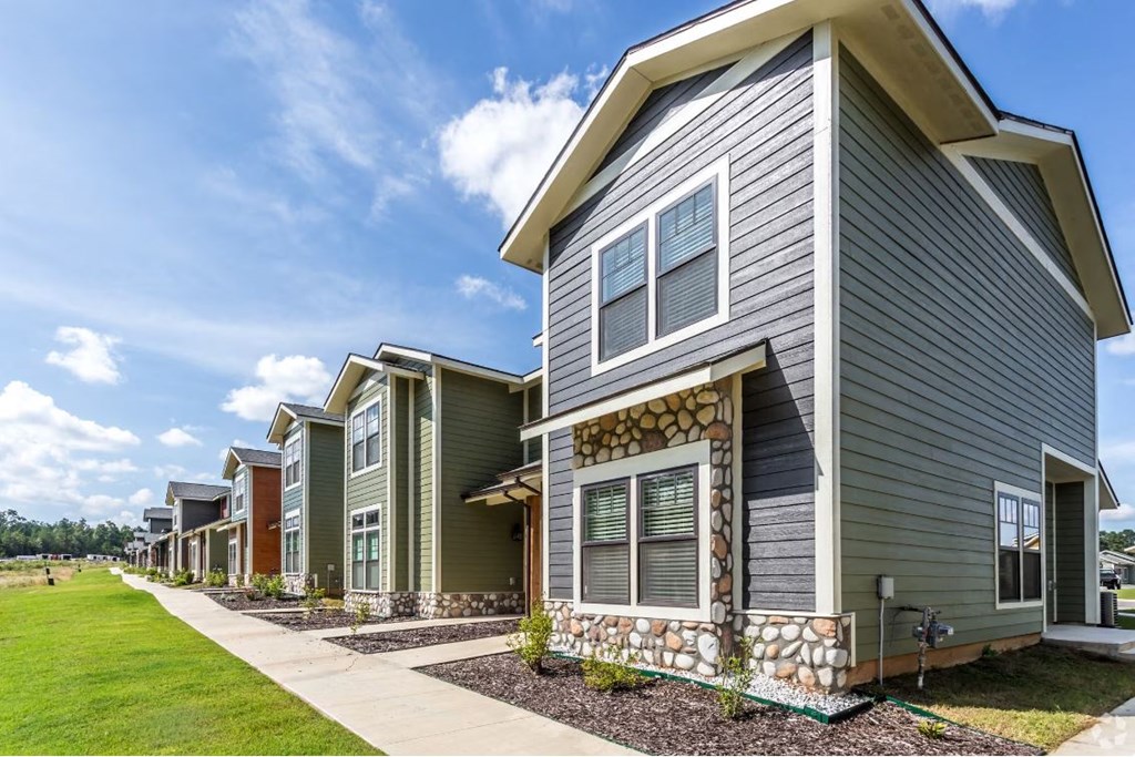 a row of townhomes with a blue sky in the background