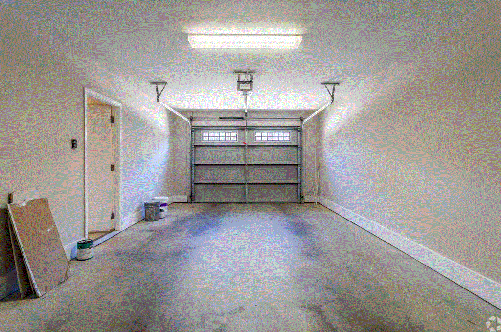 an empty garage with a garage door open