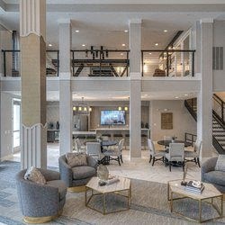a living room filled with furniture and a flat screen tv