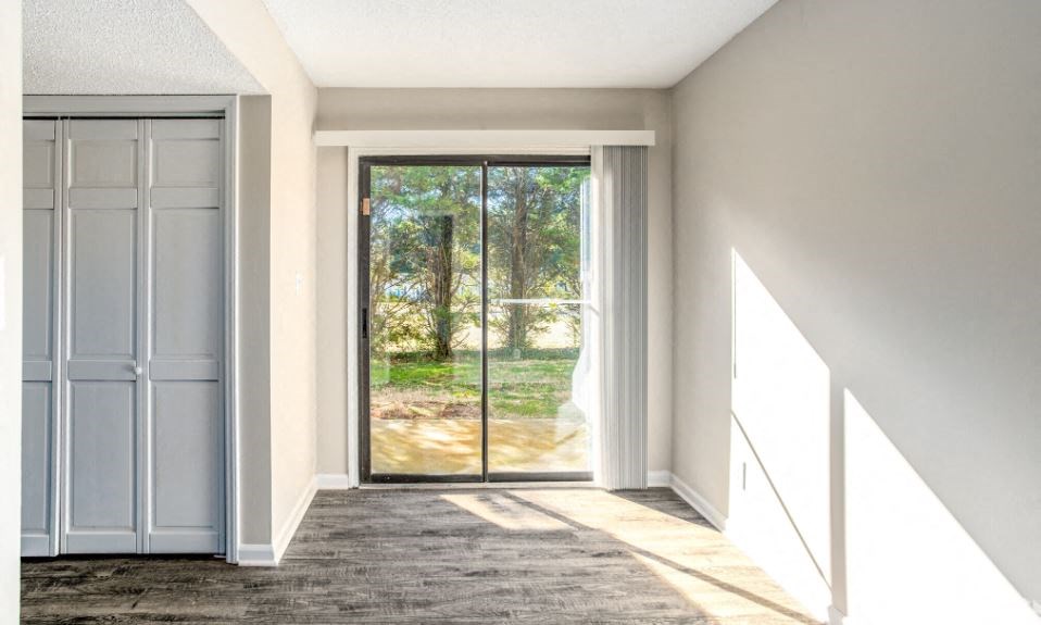 an empty room with a sliding glass door
