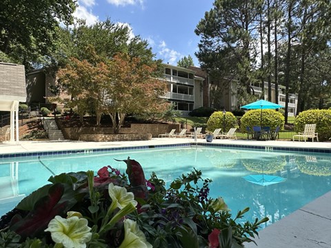 a swimming pool with a building in the background