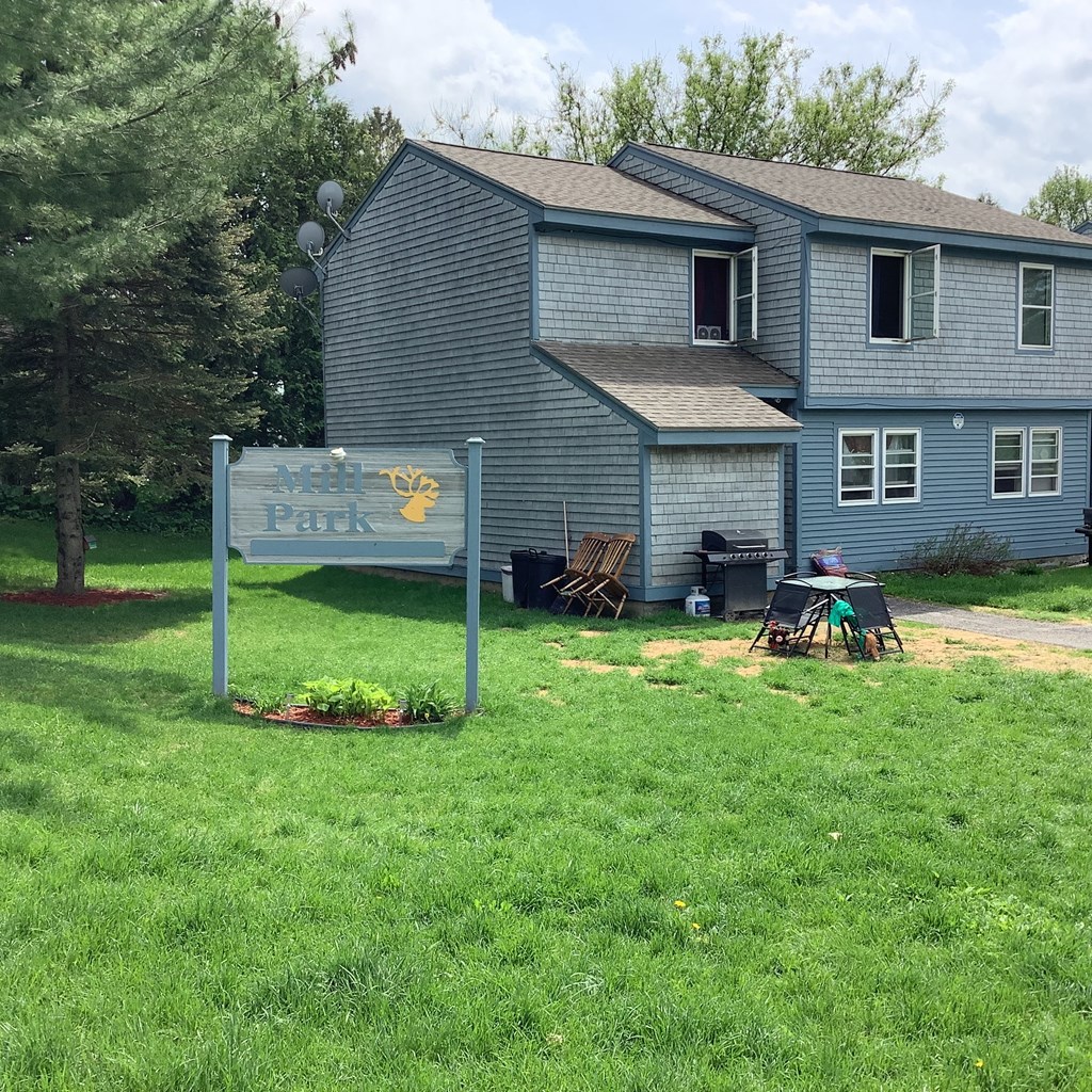 an image of a house with a sign in front of it
