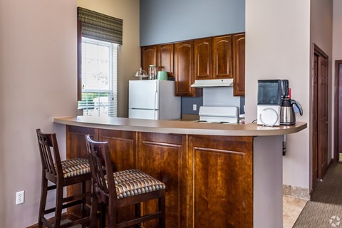 A kitchen with a white refrigerator and a white dishwasher.