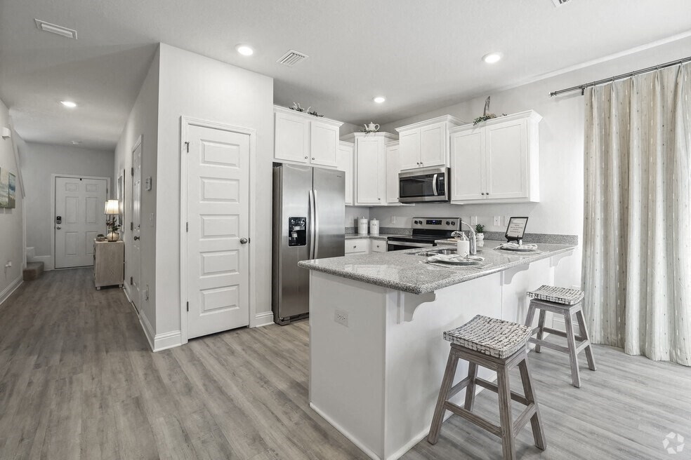 a kitchen with a counter top and a refrigerator