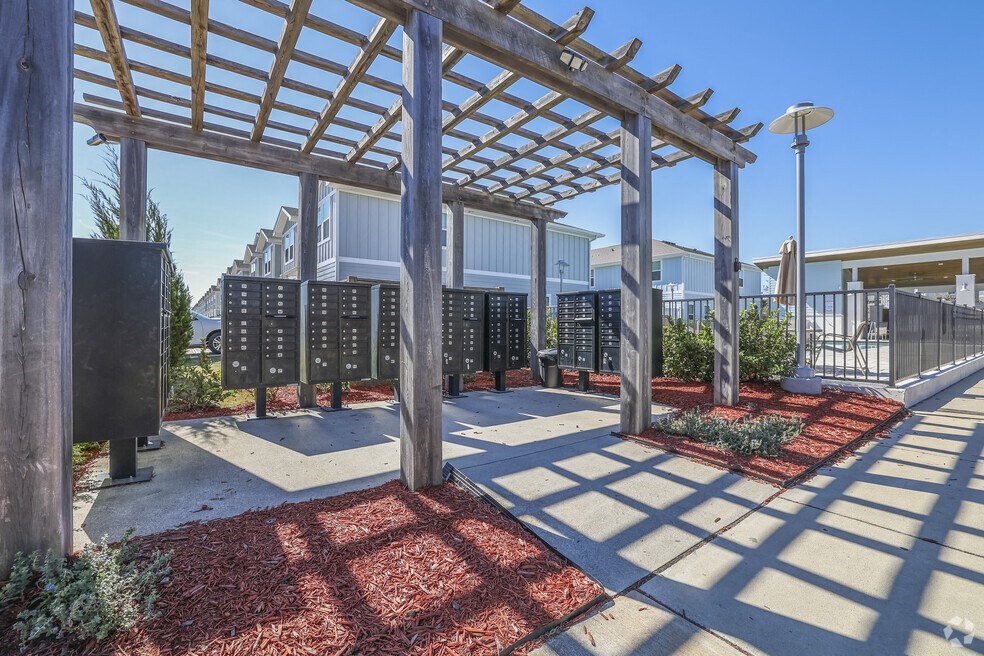 a pergola over a sidewalk in front of a building