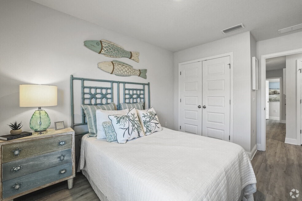 a bedroom with a bed and fish decorations on the wall