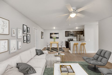 A living room with a white couch, a grey armchair, and a coffee table.