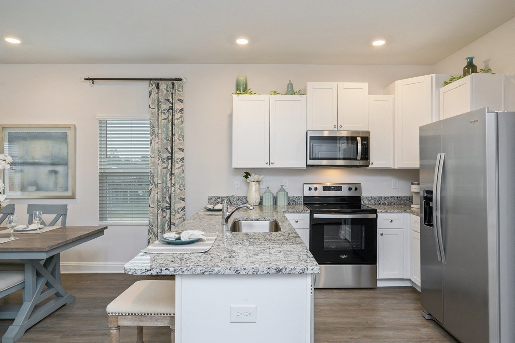 a kitchen with stainless steel appliances and a granite counter top