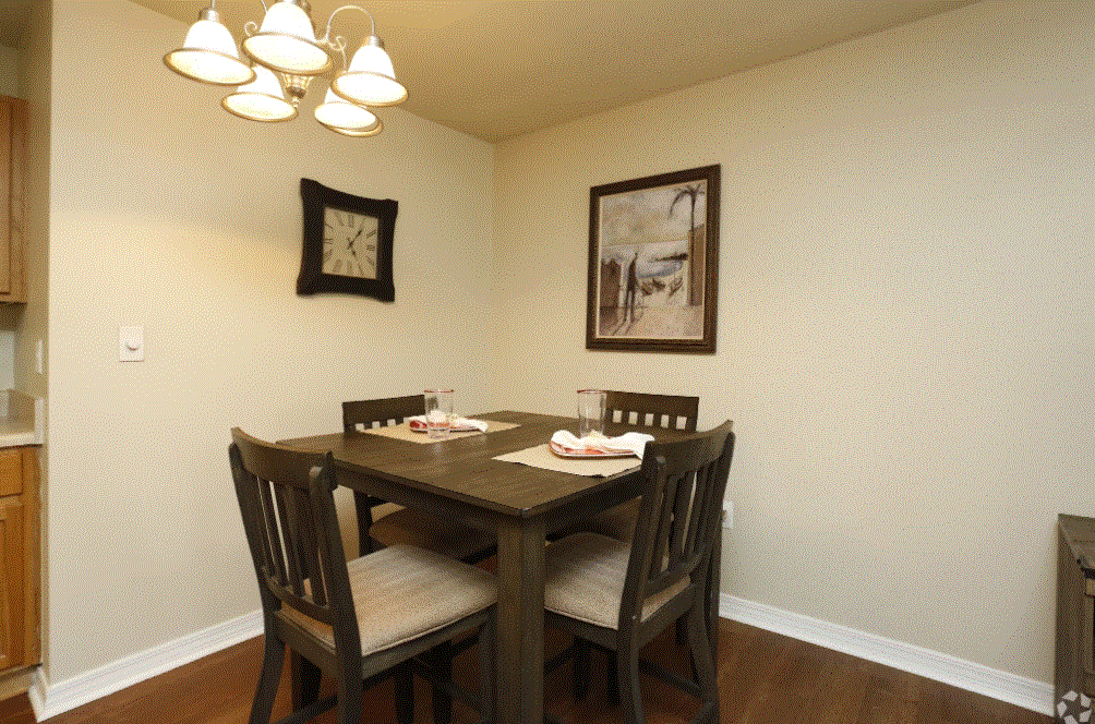 a dining room with a table and chairs