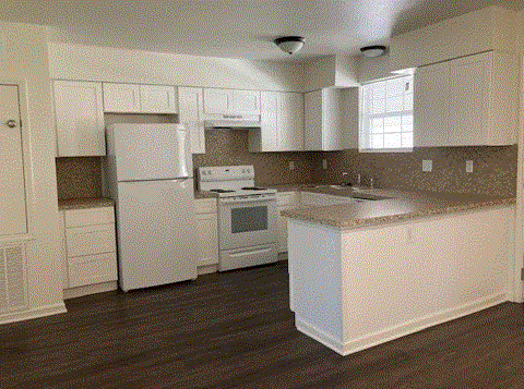 a kitchen with white appliances and a counter top