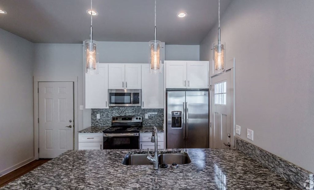 a kitchen with a sink and a refrigerator
