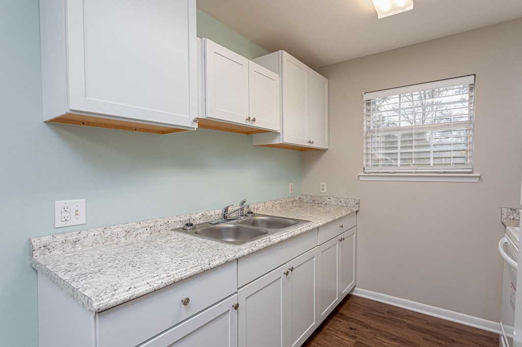 a kitchen with white cabinets and a sink