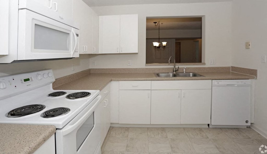 a kitchen with a stove top oven next to a sink