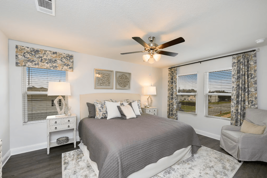 a bedroom with a bed and a ceiling fan