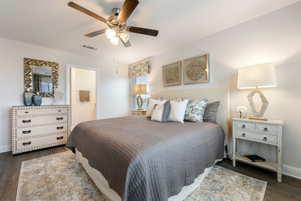 the preserve at ballantyne commons spacious bedroom with bed and ceiling fan