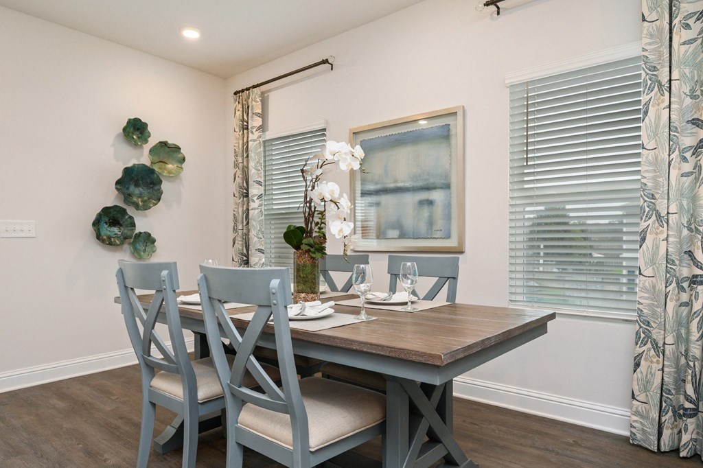 a dining room with a table and chairs and a window