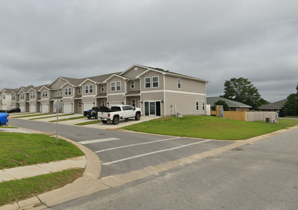 a row of houses on the corner of a street