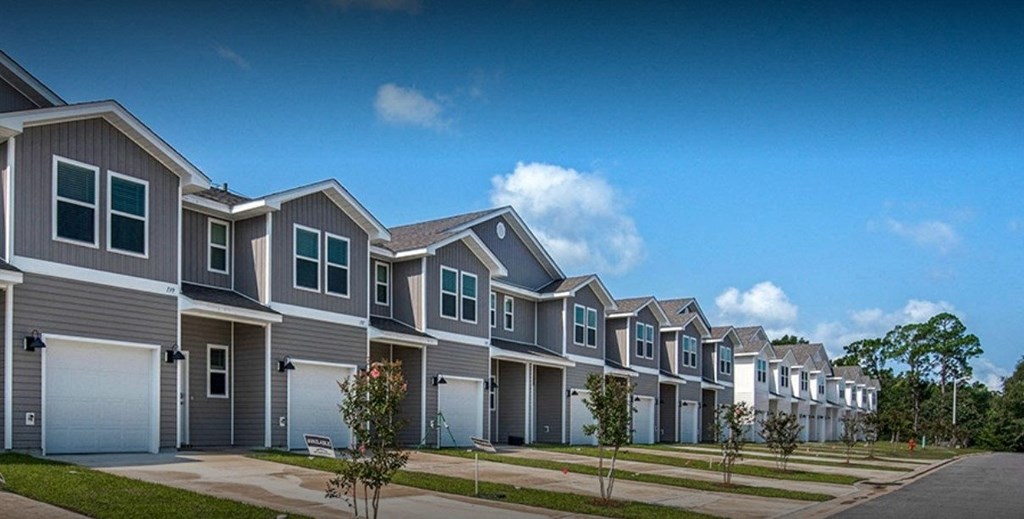 a row of houses with garage doors