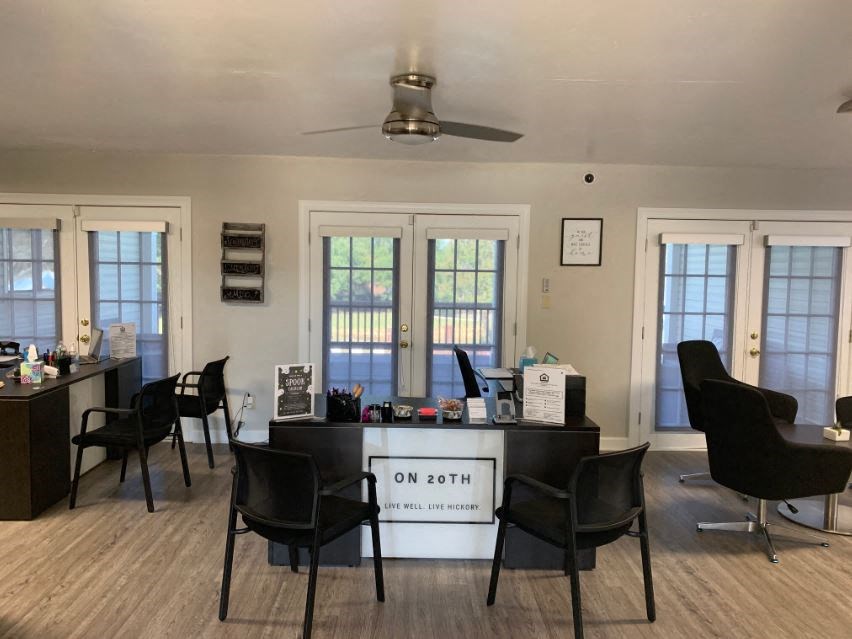 a room with a desk and chairs in it