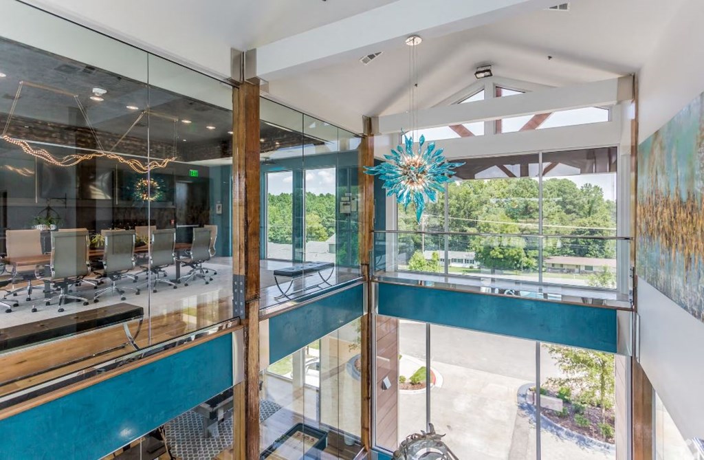 a glass walled office with a view of the outdoors