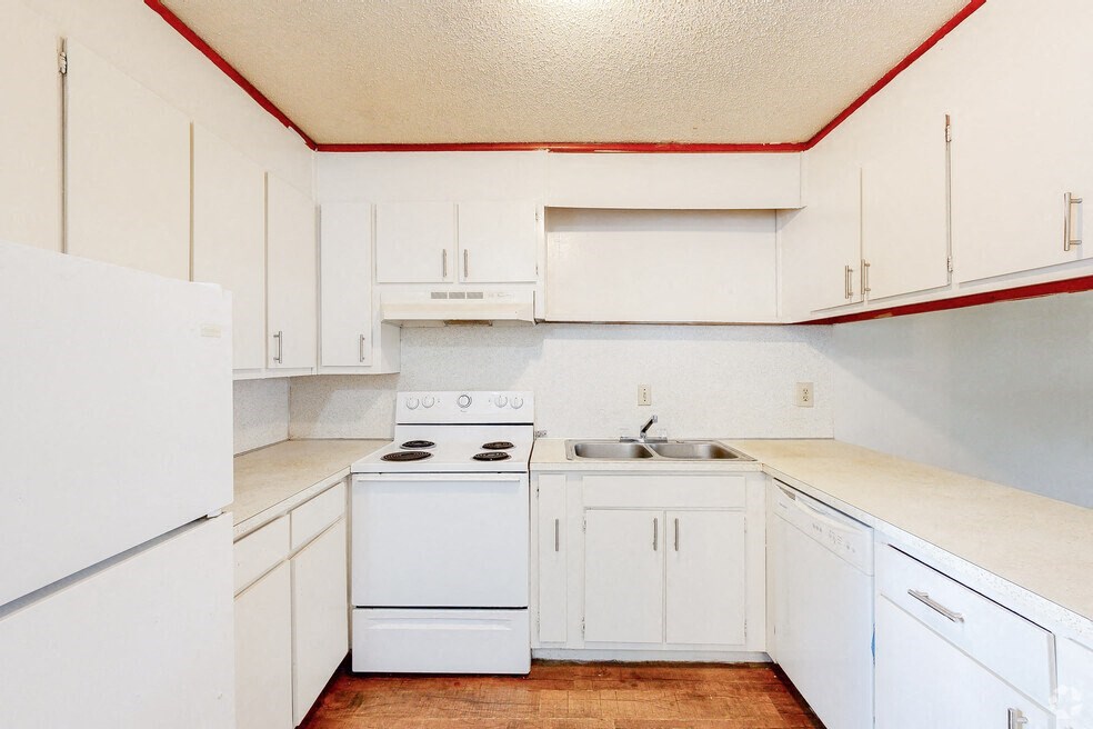 a white kitchen with white appliances and white cabinets