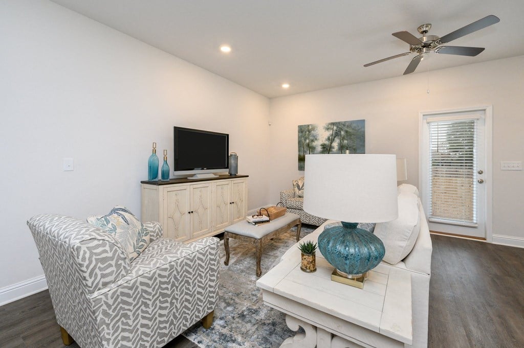 a living room with a white couch and a tv