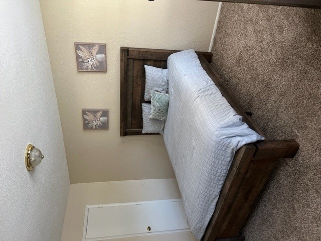 a bedroom with a bed in a small room