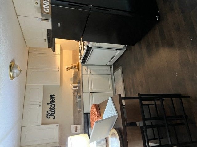 a kitchen with a stove top oven next to a refrigerator