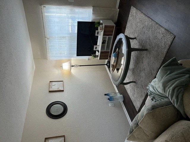 a living room with a tv and a fan
