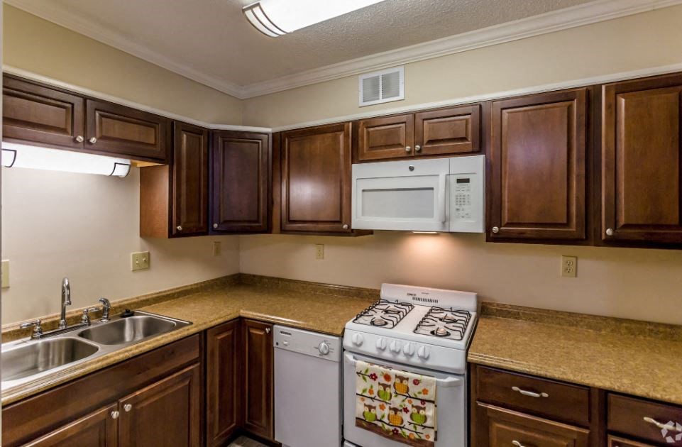 a kitchen with a stove microwave and a sink