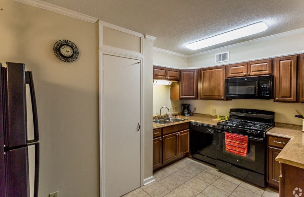 a kitchen with a stove refrigerator and a sink