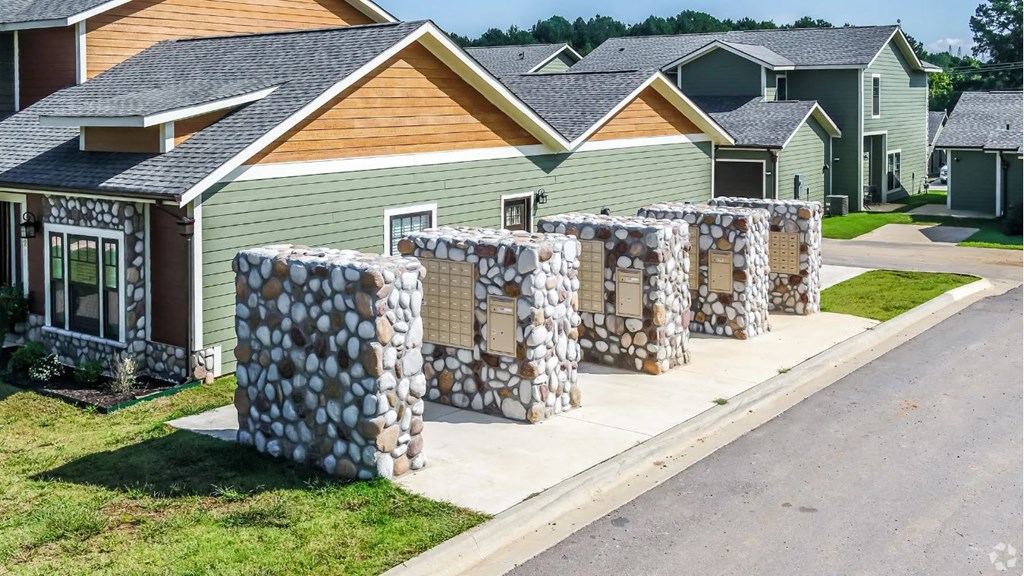 a row of houses with stacks of rocks in front of them