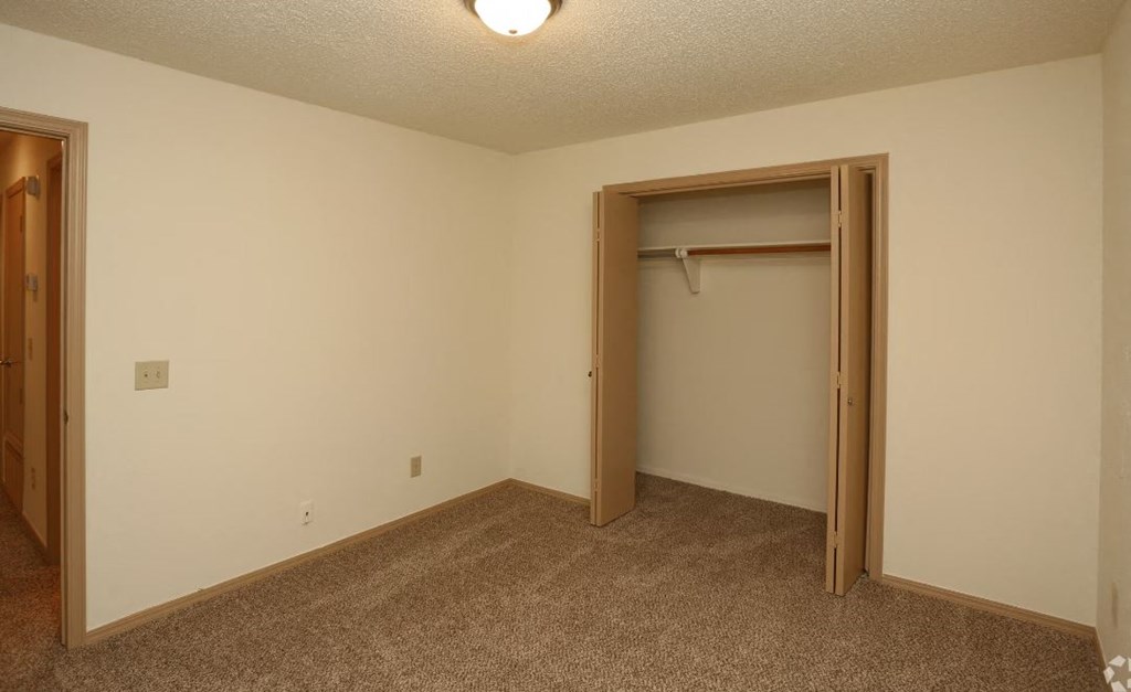 a bedroom with a closet and a door to a closet