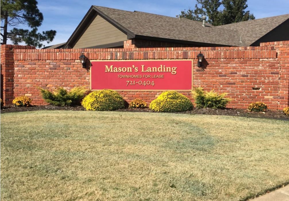 a red brick building with a sign for masons landing