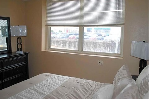 a bedroom with a bed and a window