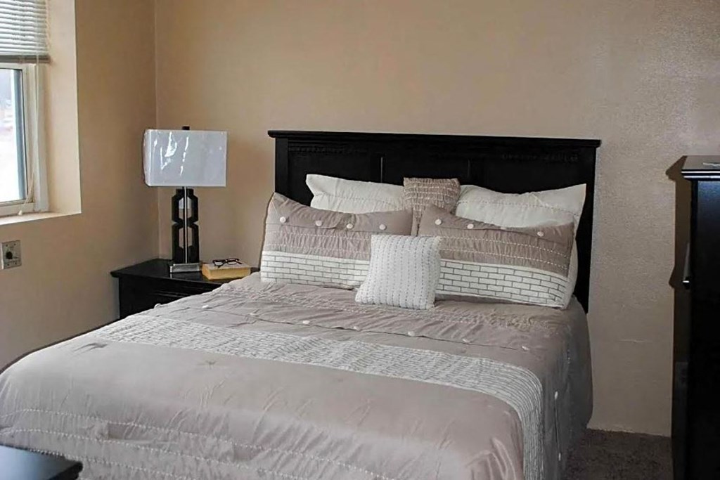 a bedroom with a bed and two nightstands