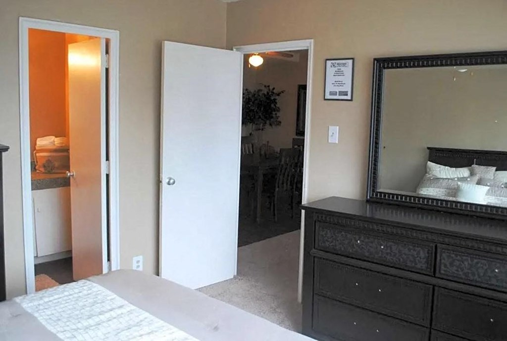 a bedroom with a bed and a mirror