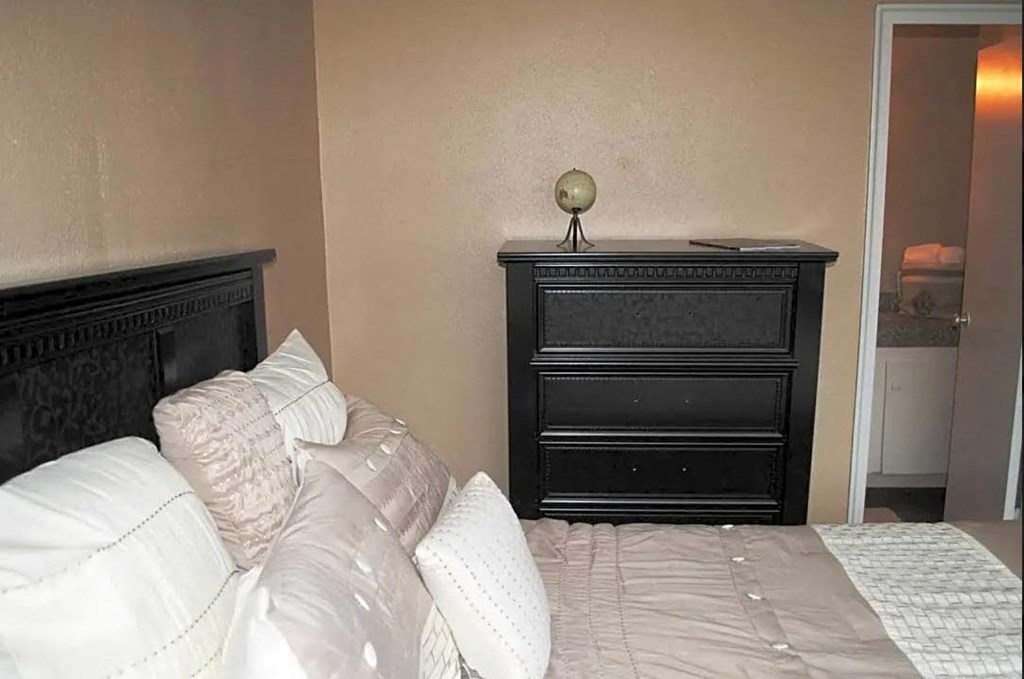 a bedroom with a bed and a dresser