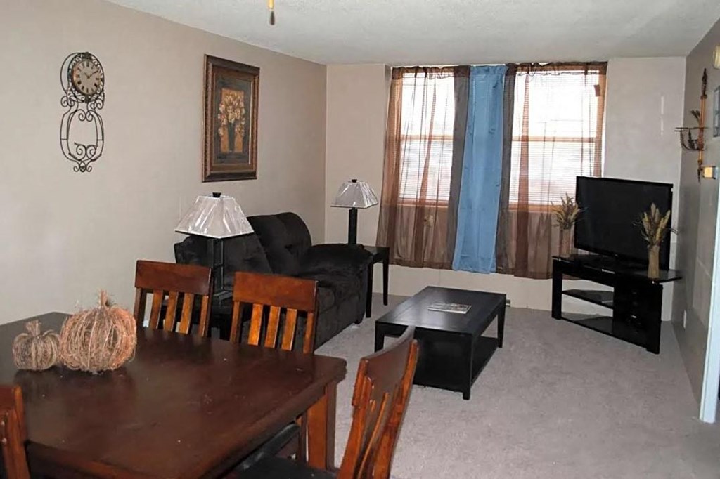 a living room filled with furniture and a flat screen tv