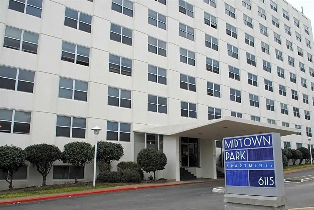 a large white building with a sign in front of it