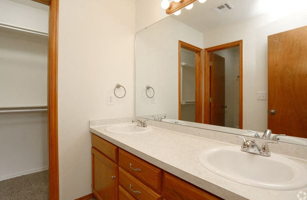 a bathroom with two sinks and a mirror