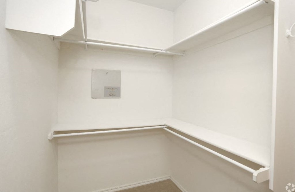 a small room with a white wall and a window