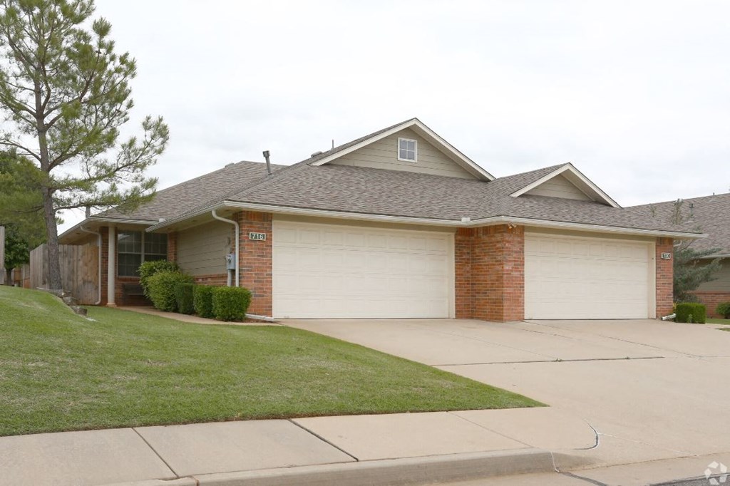 a house with two garage doors on a driveway