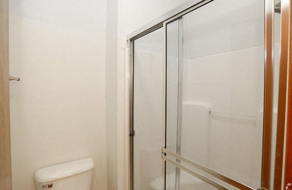 a bathroom with a toilet and a glass shower
