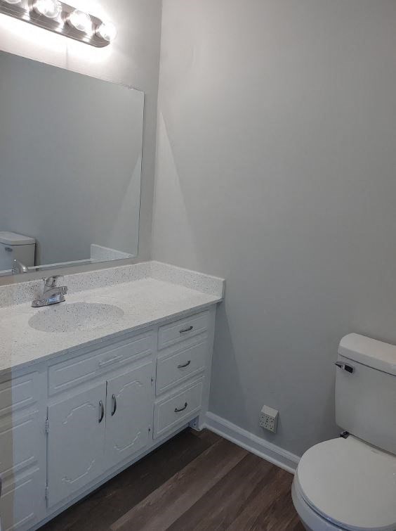 a bathroom with a toilet and a sink and a mirror