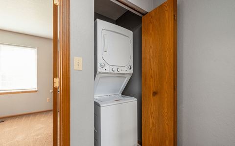 an empty laundry room with a washer and dryer in it