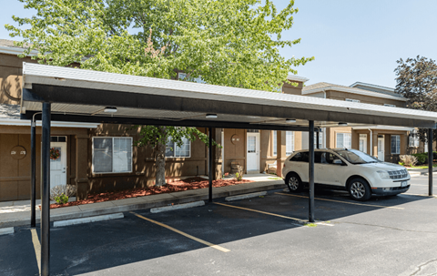 a car parked in a parking lot in front of a building
