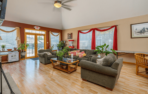 a living room with couches and chairs and a wood floor
